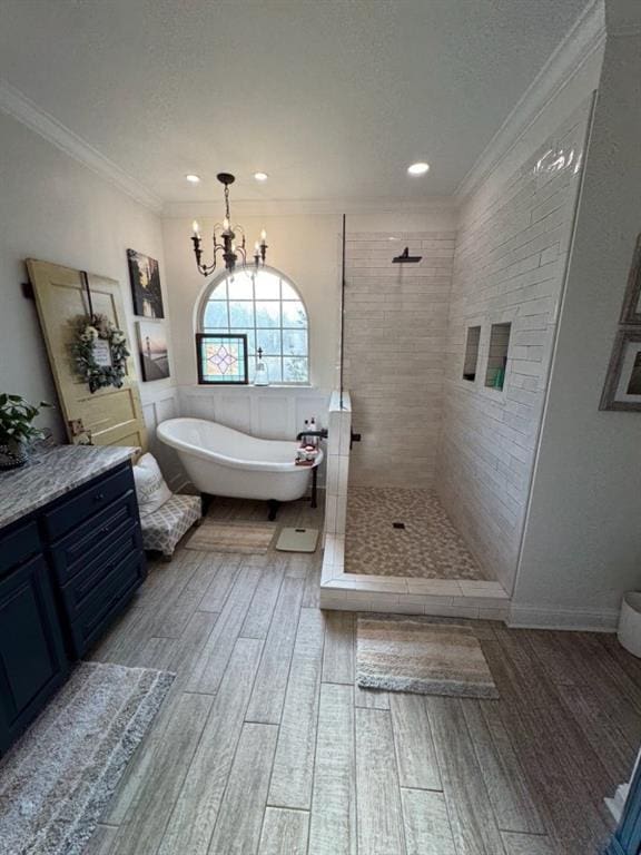 5541 Riverwood Lndg, Theodore, AL 36582 - bathroom with a soaking tub, wood finished floors, a tile shower, a chandelier, and crown molding