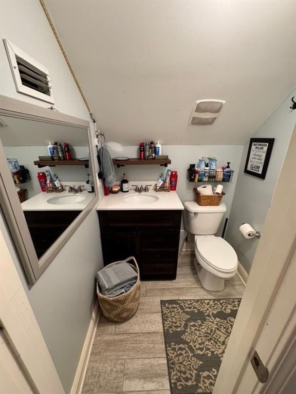 5541 Riverwood Lndg, Theodore, AL 36582 - half bathroom with vanity, wood finished floors, and vaulted ceiling