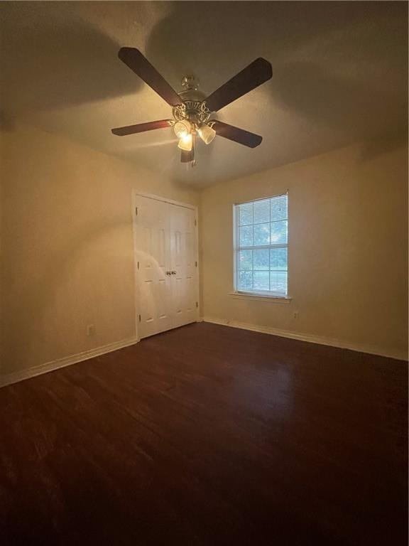 spare room with wood-type flooring and ceiling fan