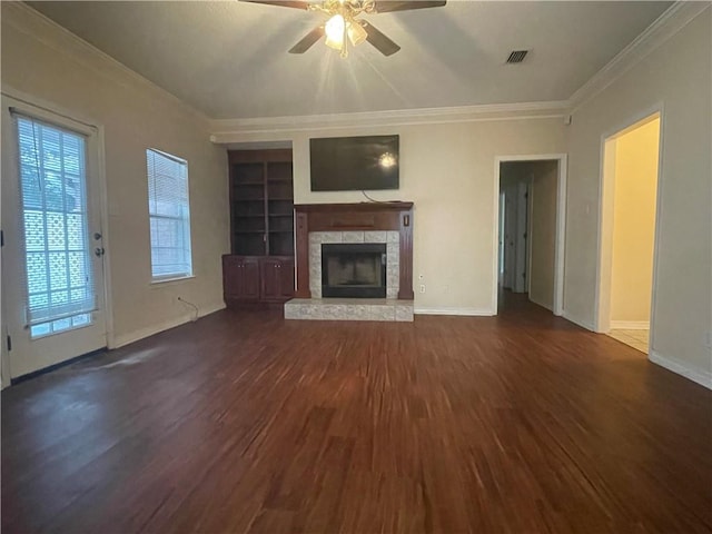 unfurnished living room featuring built in shelves, crown molding, ceiling fan, and dark wood-type flooring