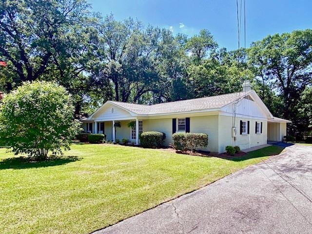 1313 Innsbruck Dr, Mobile, AL 36608 - ranch-style home with driveway, a front yard, and a chimney