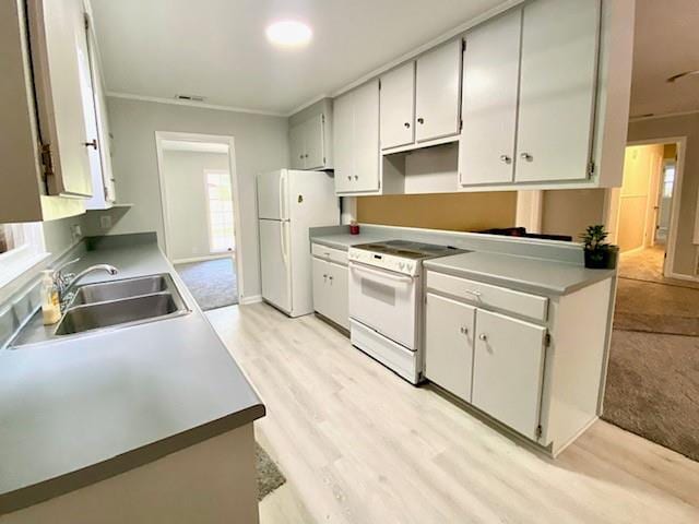 1313 Innsbruck Dr, Mobile, AL 36608 - kitchen featuring white appliances, a sink, ornamental molding, light wood-style floors, and white cabinets