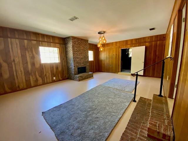 1313 Innsbruck Dr, Mobile, AL 36608 - unfurnished living room with wood walls and a fireplace