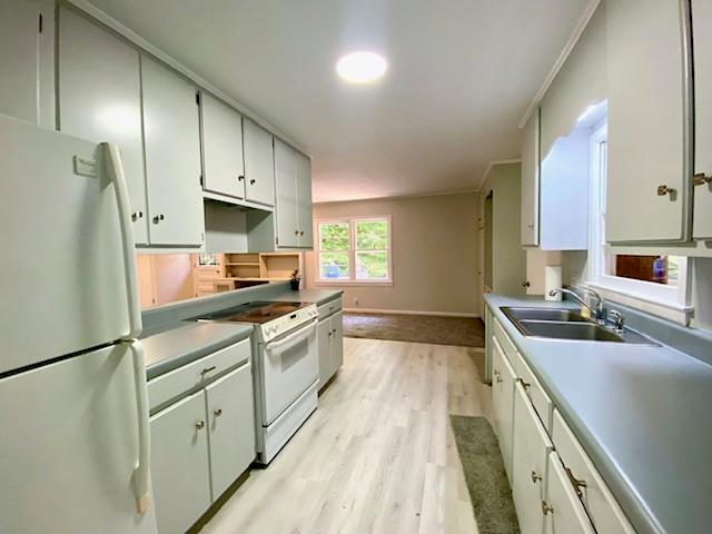 1313 Innsbruck Dr, Mobile, AL 36608 - kitchen with white appliances, a sink, light wood-style floors, baseboards, and ornamental molding