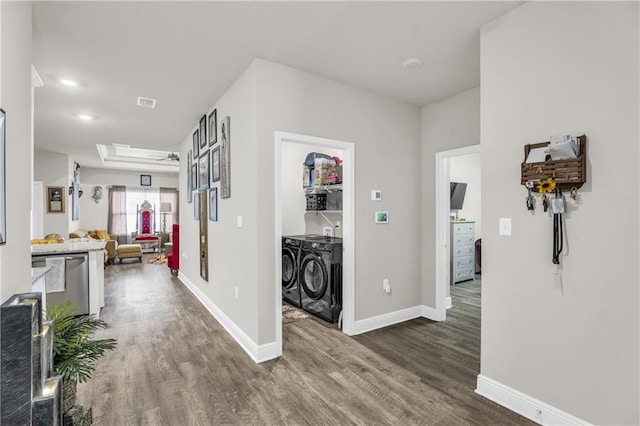 hallway with washing machine and dryer and hardwood / wood-style flooring