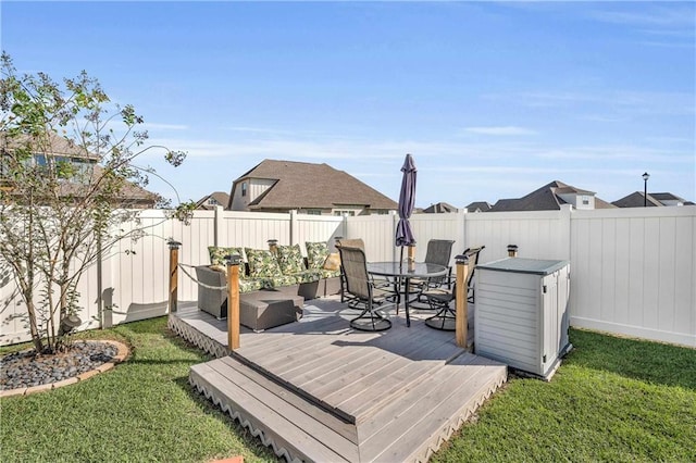 wooden deck featuring a lawn