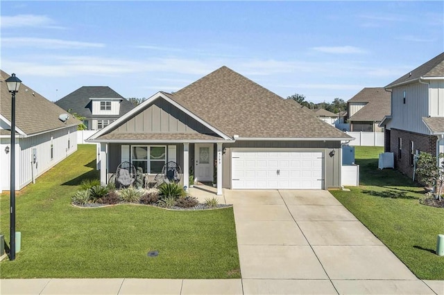 view of front of property featuring a porch, a front yard, and a garage