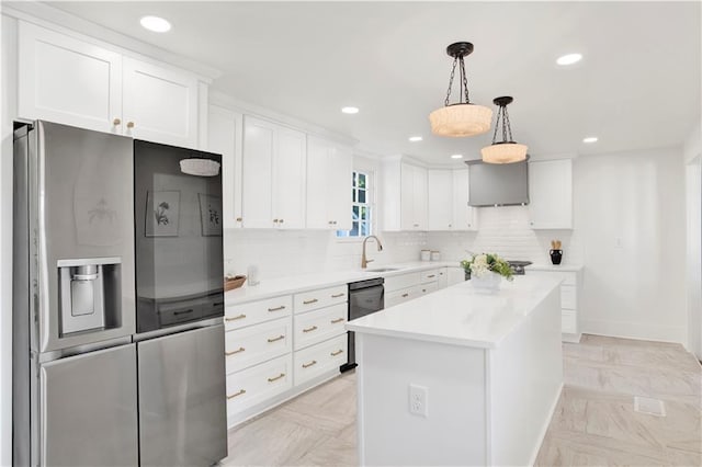 kitchen featuring stainless steel fridge with ice dispenser, a sink, white cabinetry, light countertops, and decorative light fixtures