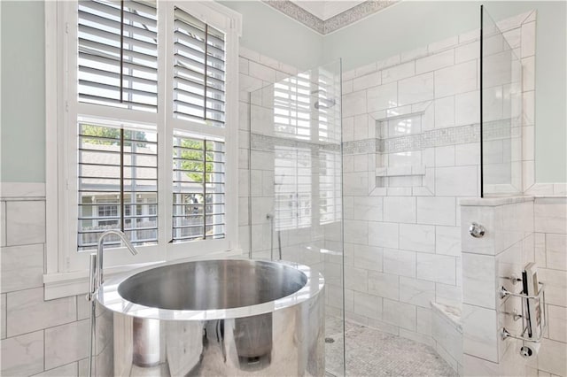 full bathroom with a soaking tub, a walk in shower, and tile walls
