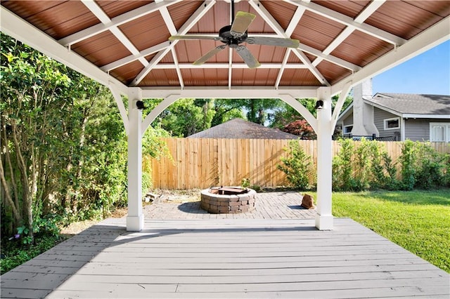 wooden terrace featuring an outdoor fire pit, a gazebo, and ceiling fan
