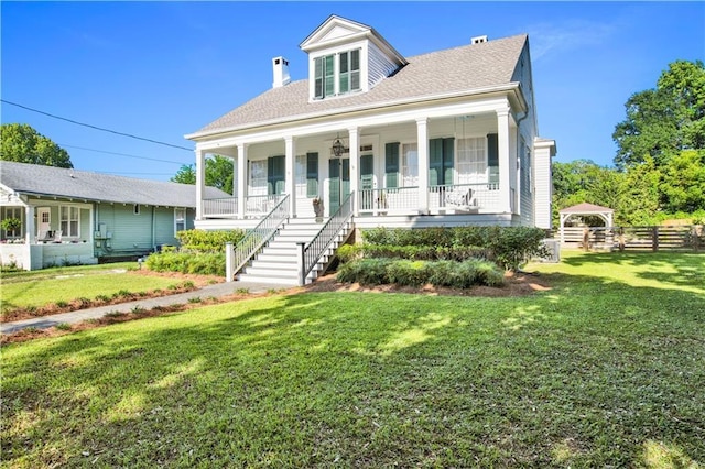 view of front facade with a porch, stairs, and a shingled roof