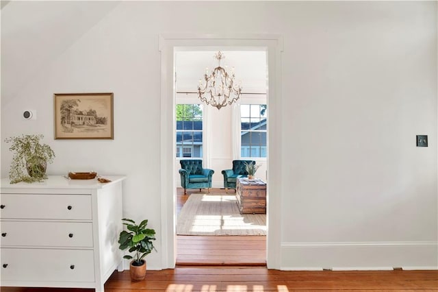 doorway featuring a chandelier and wood finished floors