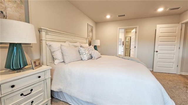 bedroom with connected bathroom, light colored carpet, visible vents, and recessed lighting