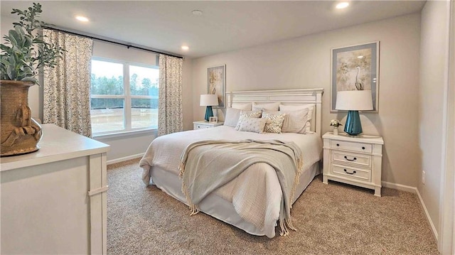 bedroom featuring recessed lighting, light carpet, and baseboards