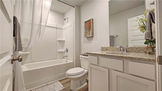 full bath featuring toilet, bathing tub / shower combination, vanity, and wood finished floors