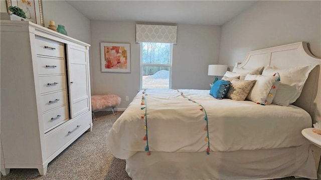 carpeted bedroom featuring baseboards