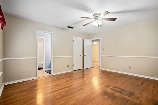 5175 Somerset Dr W, Mobile, AL 36619 - unfurnished bedroom with wood finished floors, baseboards, ensuite bathroom, and a ceiling fan