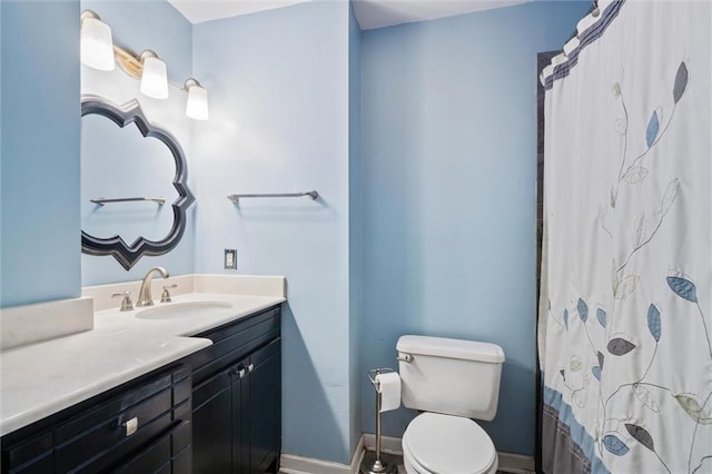 5175 Somerset Dr W, Mobile, AL 36619 - bathroom with toilet, vanity, baseboards, and curtained shower