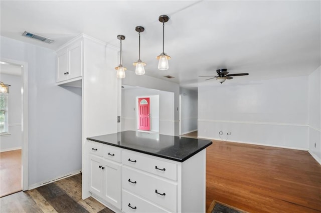 5175 Somerset Dr W, Mobile, AL 36619 - kitchen featuring a ceiling fan, dark countertops, white cabinets, dark wood finished floors, and hanging light fixtures
