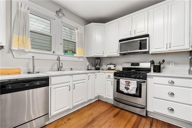 kitchen featuring light countertops, appliances with stainless steel finishes, and white cabinetry