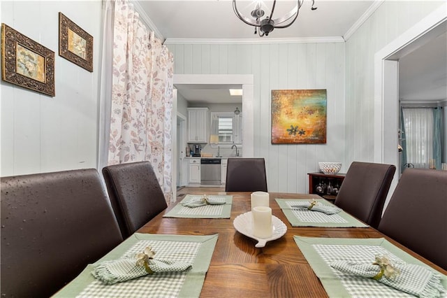 dining room with ornamental molding and a notable chandelier