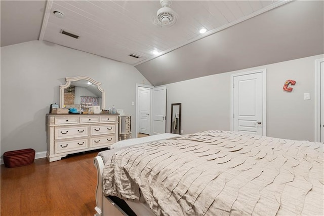 bedroom featuring dark wood-style floors, baseboards, visible vents, and vaulted ceiling