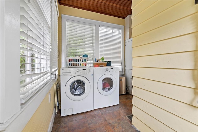 laundry area with laundry area, stone finish floor, and separate washer and dryer