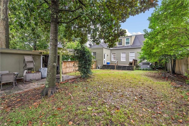 back of house featuring a fenced backyard and a wooden deck