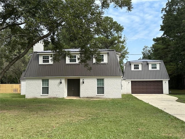 view of front of property featuring a front lawn and a garage