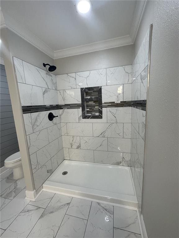 bathroom featuring toilet, tile flooring, and ornamental molding