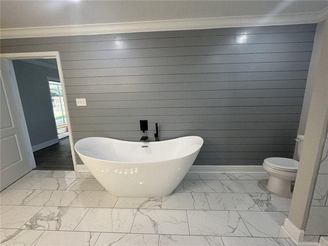 bathroom with tile flooring, ornamental molding, and a bath