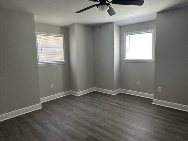 spare room featuring dark hardwood / wood-style flooring and ceiling fan