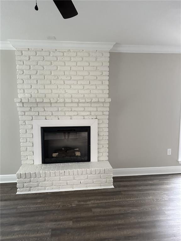 interior details featuring ornamental molding, dark hardwood / wood-style floors, ceiling fan, and a brick fireplace