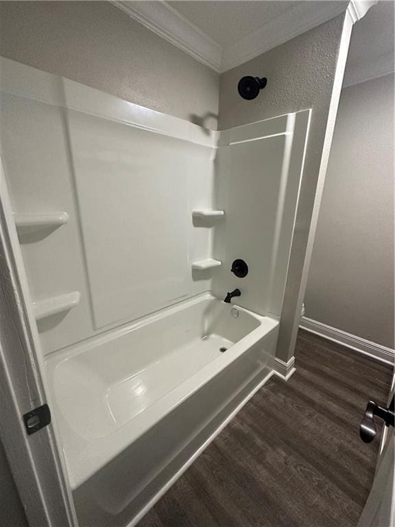 bathroom featuring crown molding, shower / bathing tub combination, and wood-type flooring