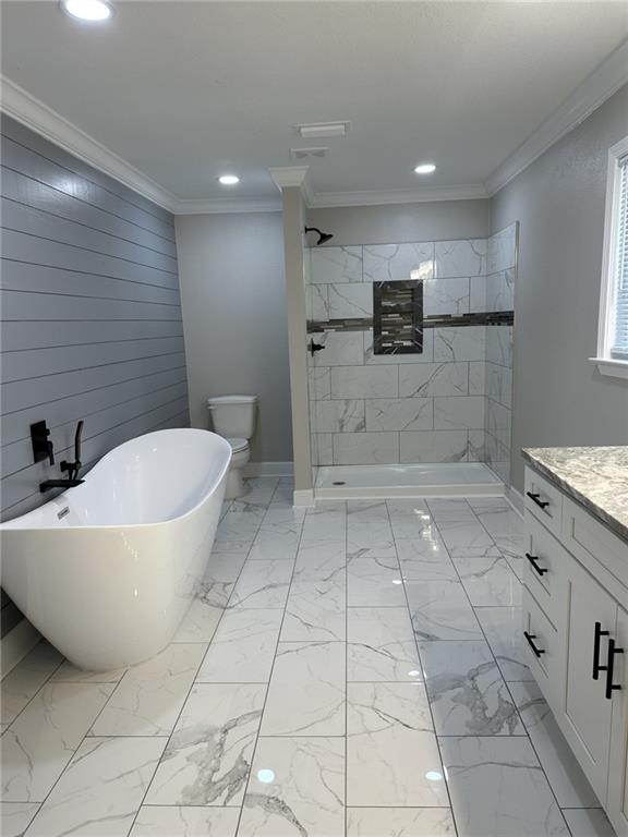 bathroom featuring toilet, ornamental molding, vanity, and tile flooring