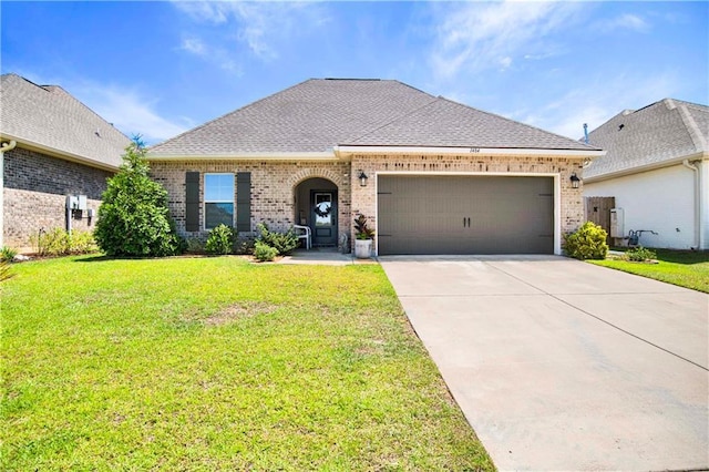 1484 Fenton Cir, Foley, AL 36535 - french country inspired facade featuring brick siding, a garage, a front lawn, concrete driveway, and roof with shingles