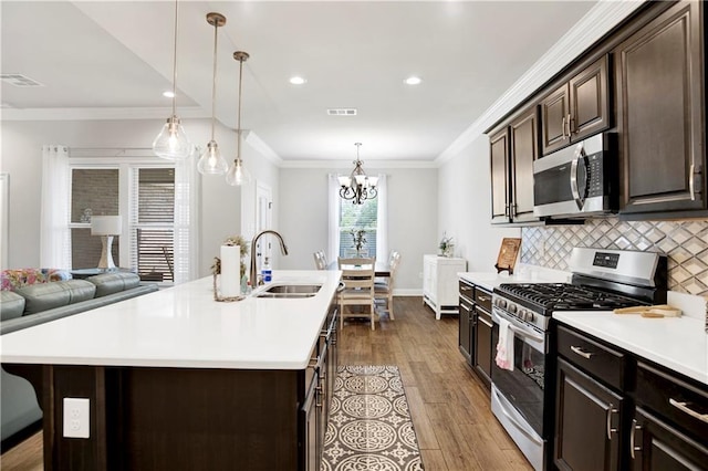 1484 Fenton Cir, Foley, AL 36535 - kitchen featuring stainless steel appliances, a sink, light countertops, dark wood-style floors, and crown molding