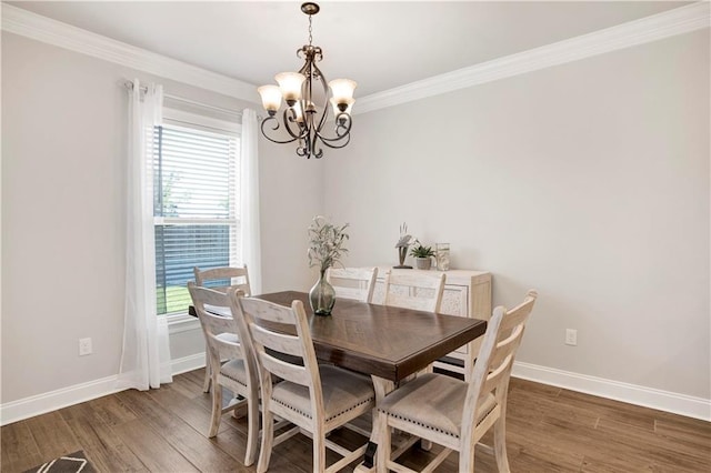 1484 Fenton Cir, Foley, AL 36535 - dining area featuring a chandelier, wood finished floors, ornamental molding, and baseboards