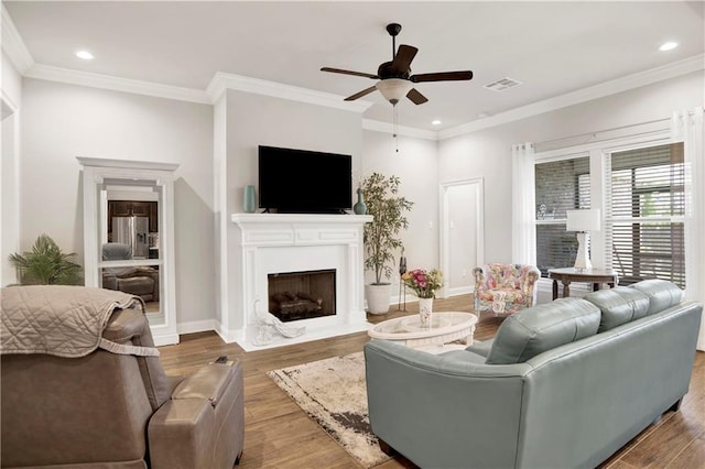 1484 Fenton Cir, Foley, AL 36535 - living area with ceiling fan, wood finished floors, a fireplace with flush hearth, recessed lighting, and ornamental molding