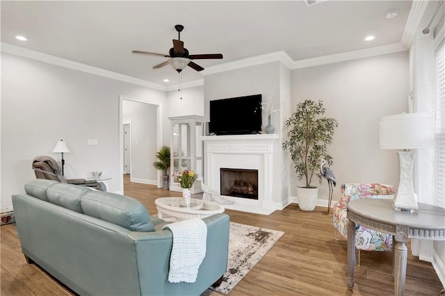 1484 Fenton Cir, Foley, AL 36535 - living room with a ceiling fan, recessed lighting, light wood-style floors, a fireplace with flush hearth, and ornamental molding