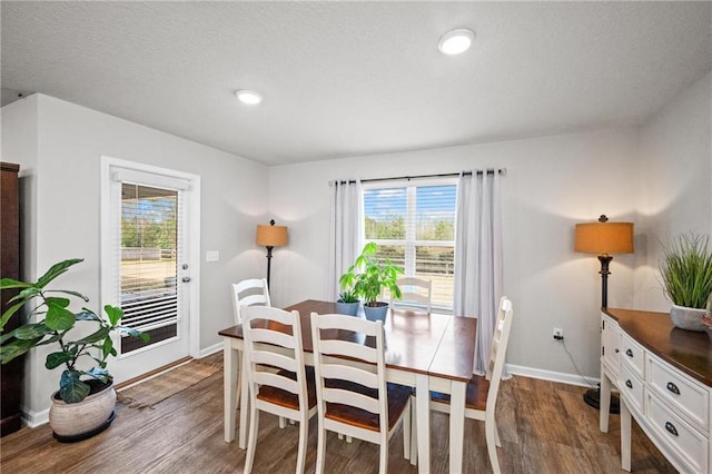 dining area featuring dark wood-type flooring and a healthy amount of sunlight