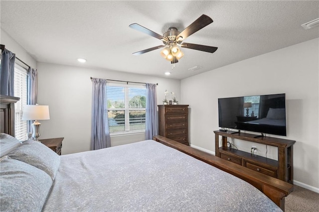 bedroom with a textured ceiling and ceiling fan