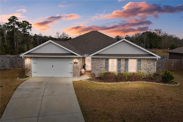 view of front of home featuring a garage and a yard