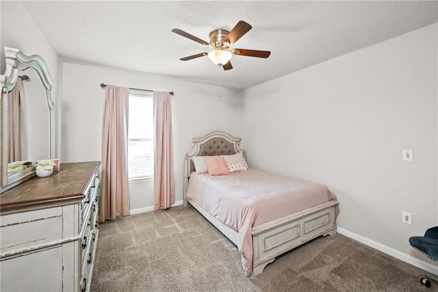 carpeted bedroom featuring ceiling fan and a textured ceiling