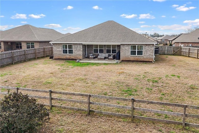 back of property with a patio and a lawn