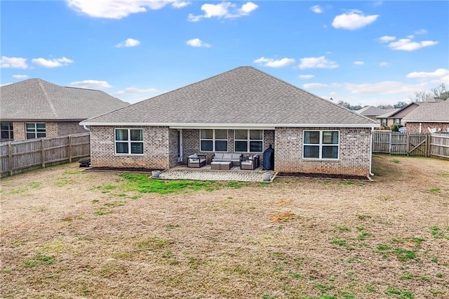 rear view of property with a patio, outdoor lounge area, and a yard