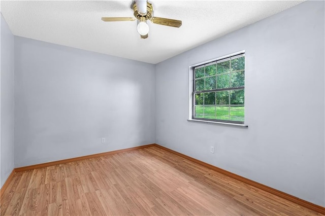 empty room featuring ceiling fan and light hardwood / wood-style floors