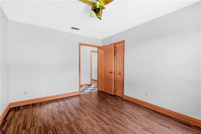 spare room with wood-type flooring