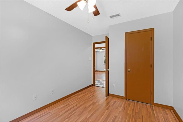 unfurnished bedroom featuring ceiling fan and light wood-type flooring