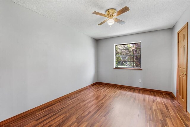 unfurnished bedroom with ceiling fan, a textured ceiling, and wood-type flooring